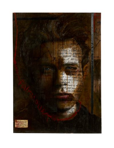 Photo of a man in the dark with a light shining on the left side of his face where are words written