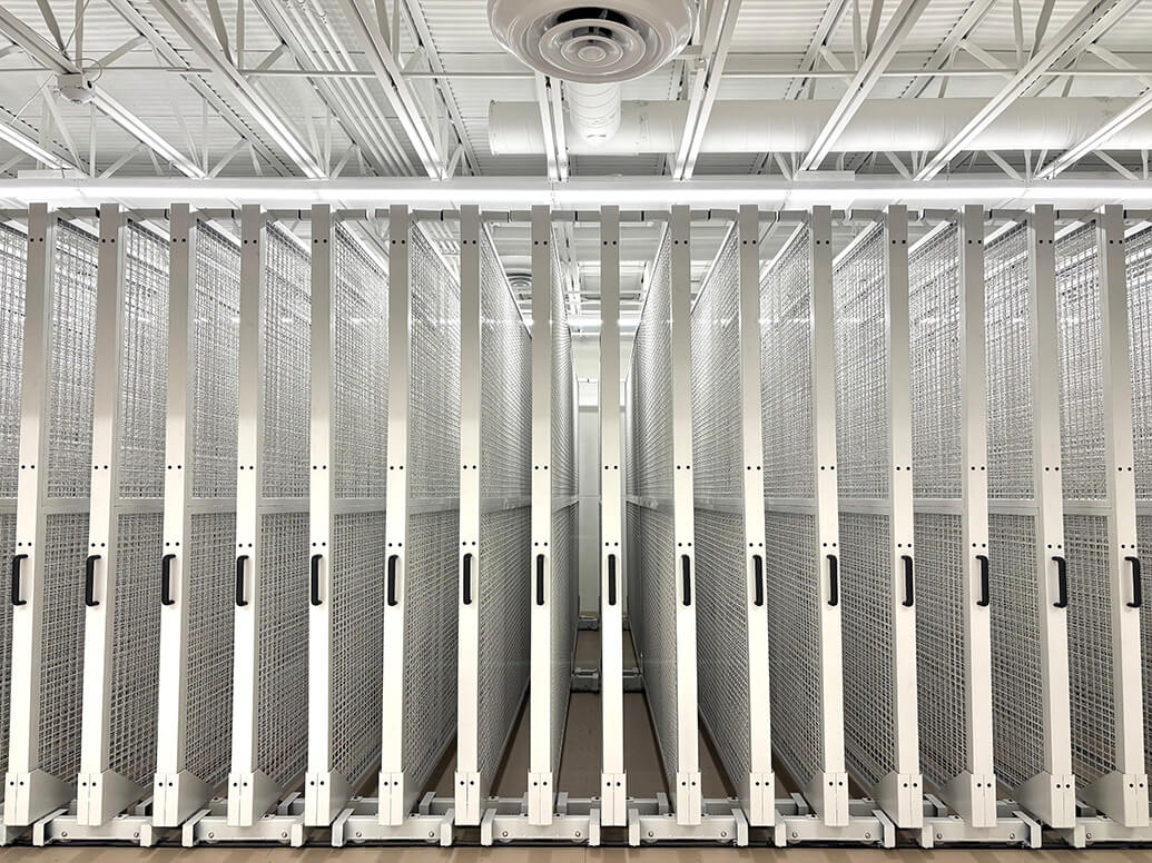 Photograph taken outside The Butler, there are three visible arches, in the center arch is a sculpture of a Native American wearing a tribal headdress, his hand rests on his forehead to block the sun from his eyes.