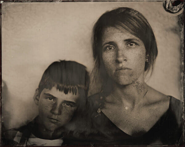 Mother and Son, 2019, ambrotype original, archival pigment print, 40″ x 50″ photograph of straight-faced mother and son siting side by side