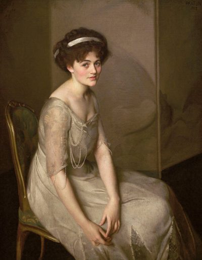 A woman in a white dress with her hair tied up with a white headband sits in a chair leaning over slightly looking directly towards the painter.