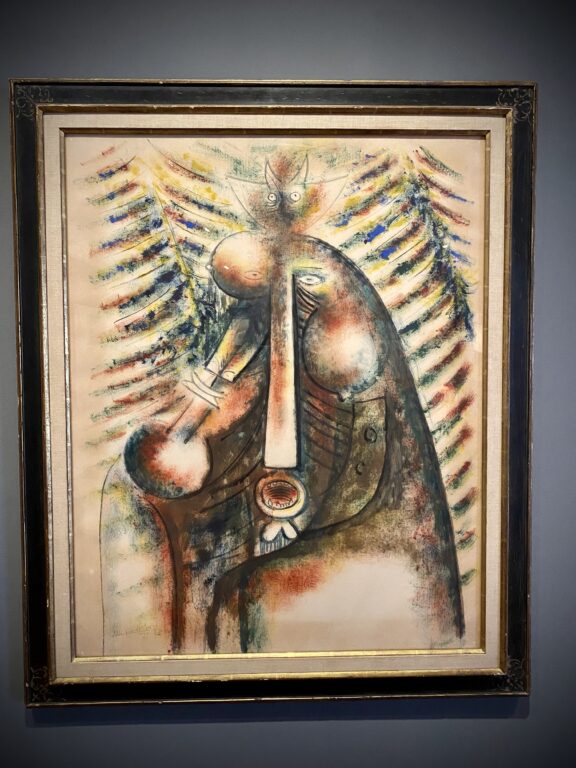 A photo of a framed, colorful abstract painting