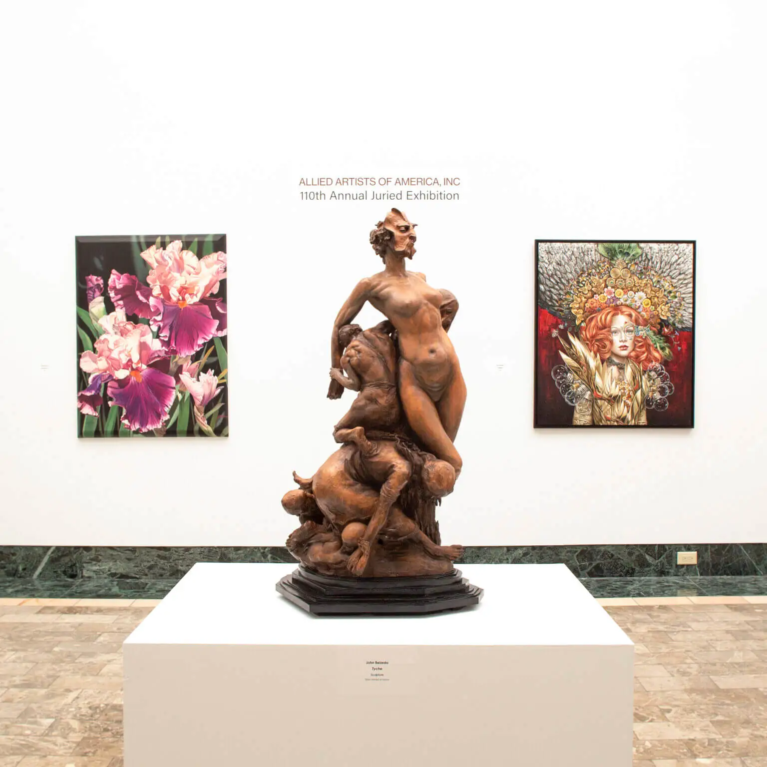 bronze status of sirens, with paintings in the background