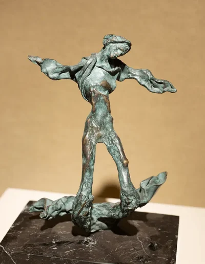 Bronze statue of man with wings on marble base